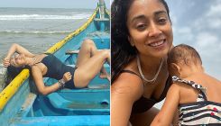 Shriya Saran looks smoking hot in a black monokini as she plays with her daughter on the beach