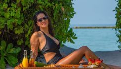 Sunny Leone raises the temperature as she poses by the pool in a black monokini